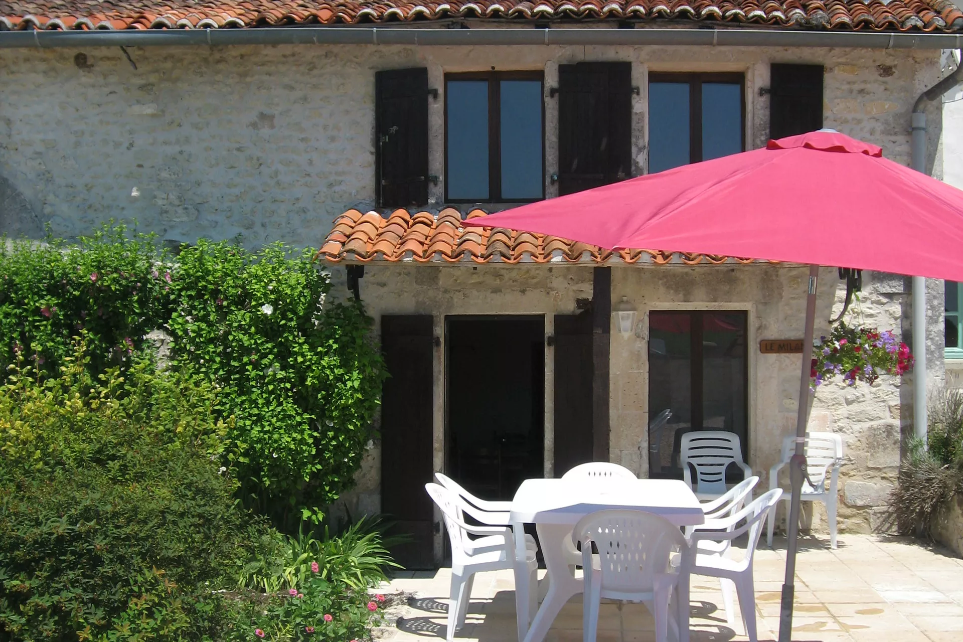Private terrace with table, chairs, BBQ and Umbrella
