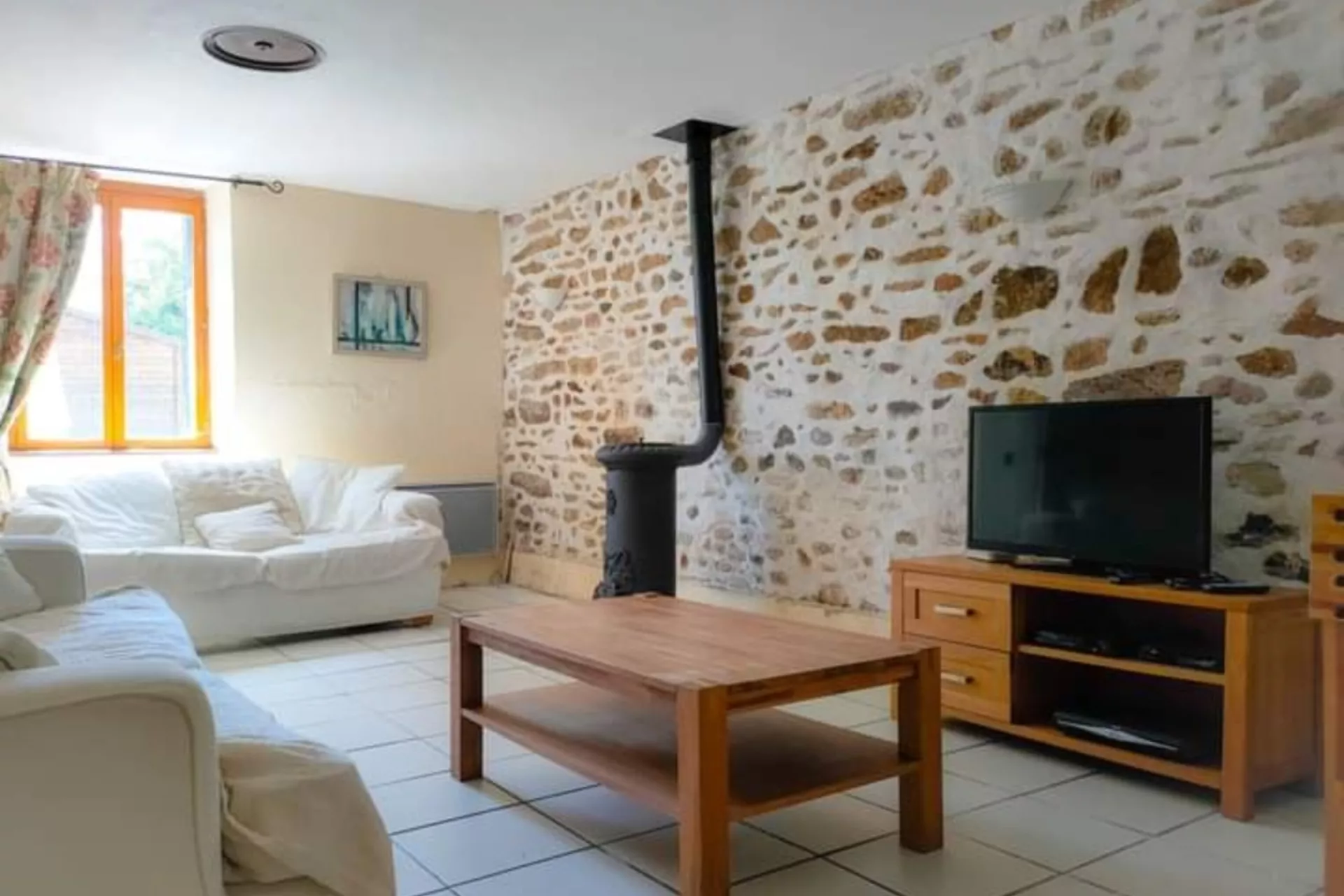 Lounge with smart TV, log burner and comfy seating.